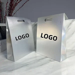 D Cut Handle Holographic Silver Paper Bag Custom Logo Retail Packaging Bag with Matt Lamination Finish for Clothing Dress
